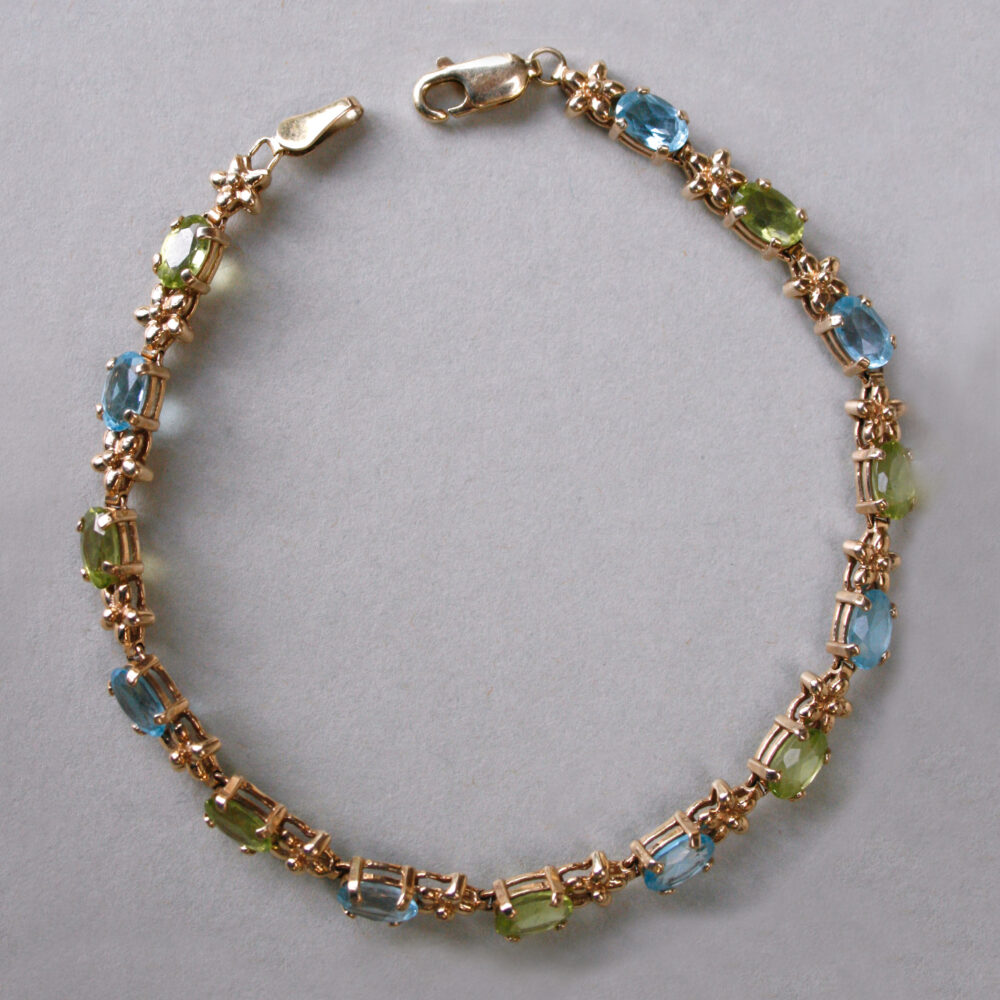 Contemporary 9ct gold blue topaz and peridot floral link bracelet
