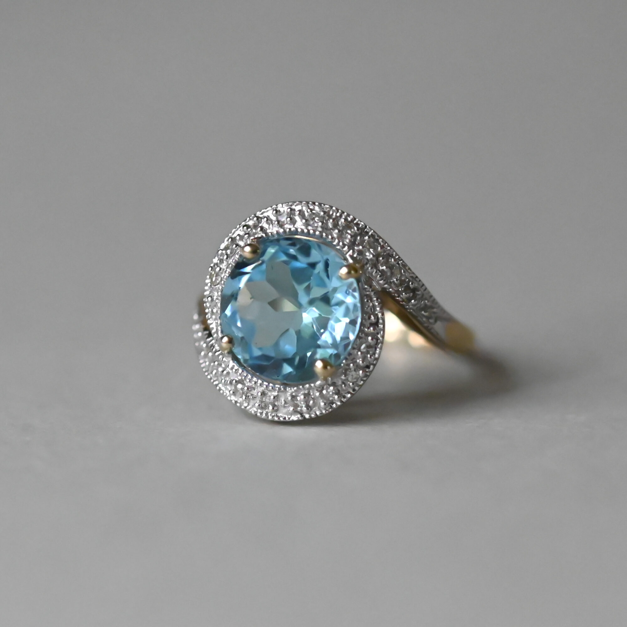 Contemporary 9ct gold blue topaz and mini diamond swirl ring - Image 2
