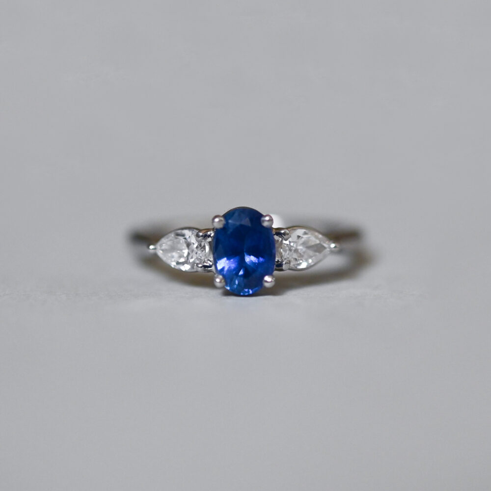 Exquisite contemporary sapphire and pear cut diamond platinum engagement ring